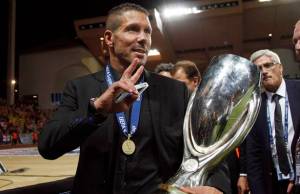 Atletico Madrid's coach Simeone holds the trophy as he  celebratesbtheir win against Chelsea in their Super Cup soccer match at Louis II stadium in Monaco